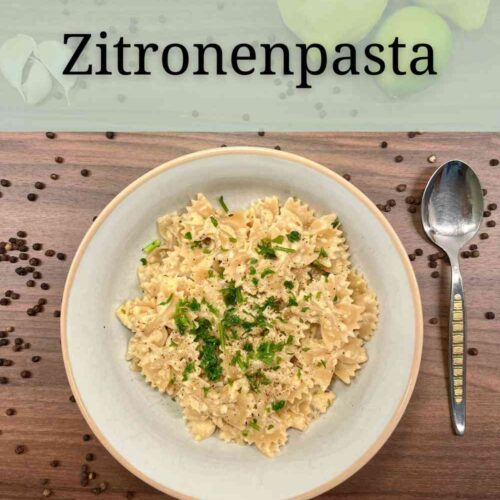 Zitronenpasta mit Kraeutern dekoriert, sind Nudeln mit Zitronensoße. Die Soße enthält Zwiebeln, Creme Vega, Ajvar, Zitronenschale und Zitronensaft.